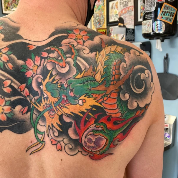 Japanese Dragon, Cherry blossoms tattoo on Shoulder Blade