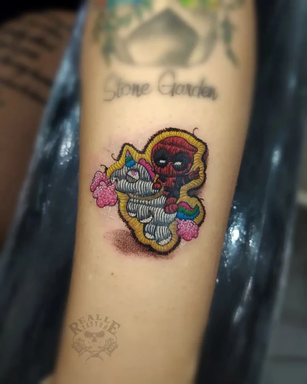 Cartoon Deadpool, Unicorn tattoo on Forearm