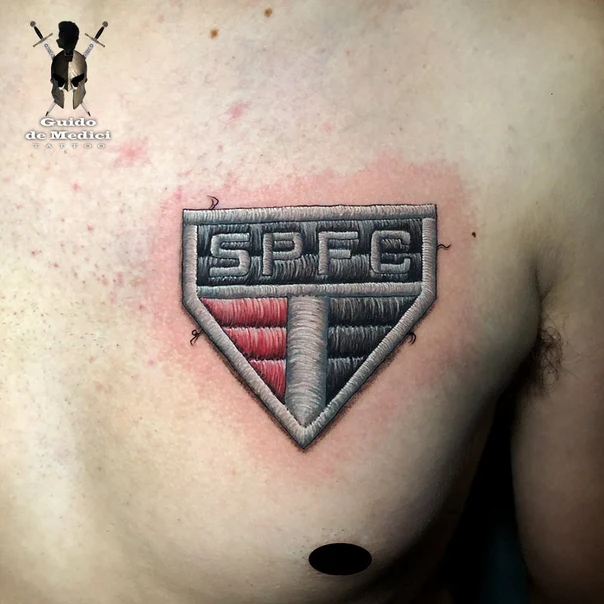 Realism Logo tattoo on Chest