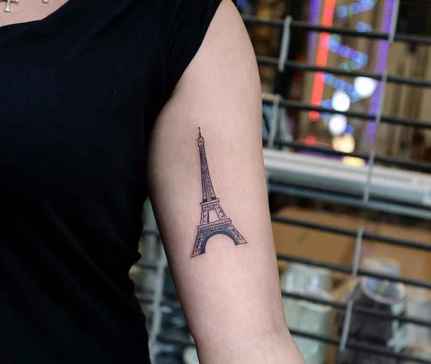 Fineline Eiffel tower tattoo on Forearm
