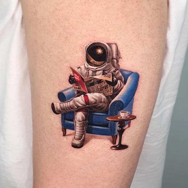 Realism Astronaut, Chair tattoo on Upper Arm