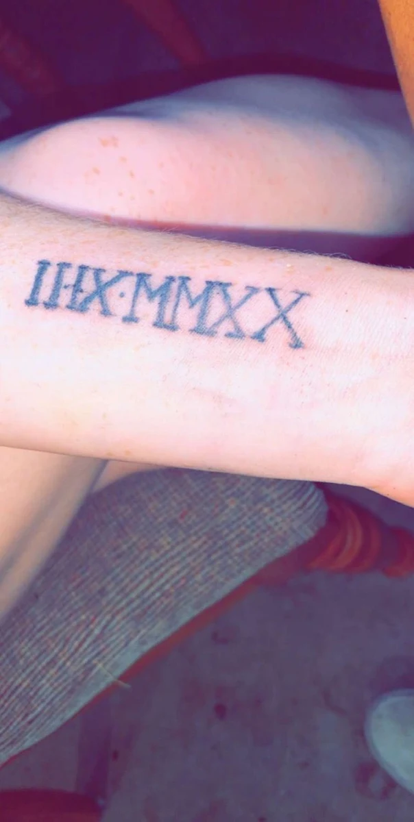 Lettering Roman numerals tattoo on Forearm