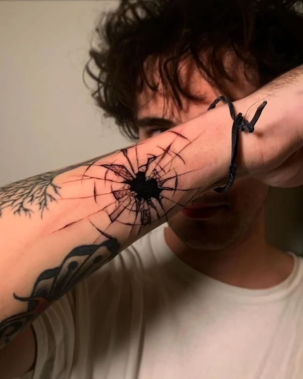 Blackwork Broken glass tattoo on Forearm