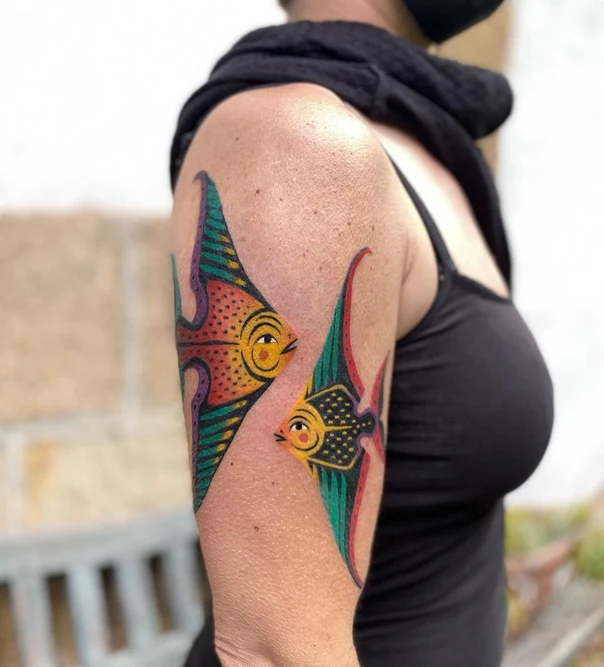 Illustrative Fish tattoo on Upper Arm