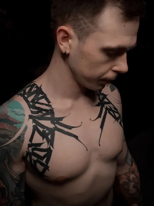 male black lettering tattoo on collarbone #55689 | Tattoo Artist Игорь Климин