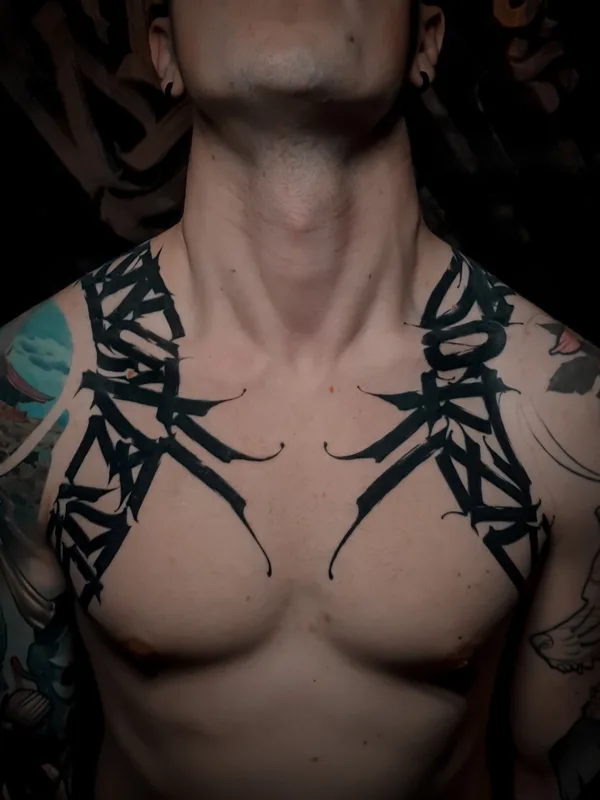 male black lettering tattoo on collarbone #55690 | Tattoo Artist Игорь Климин
