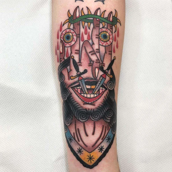 Traditional Face, Eyes tattoo on Forearm
