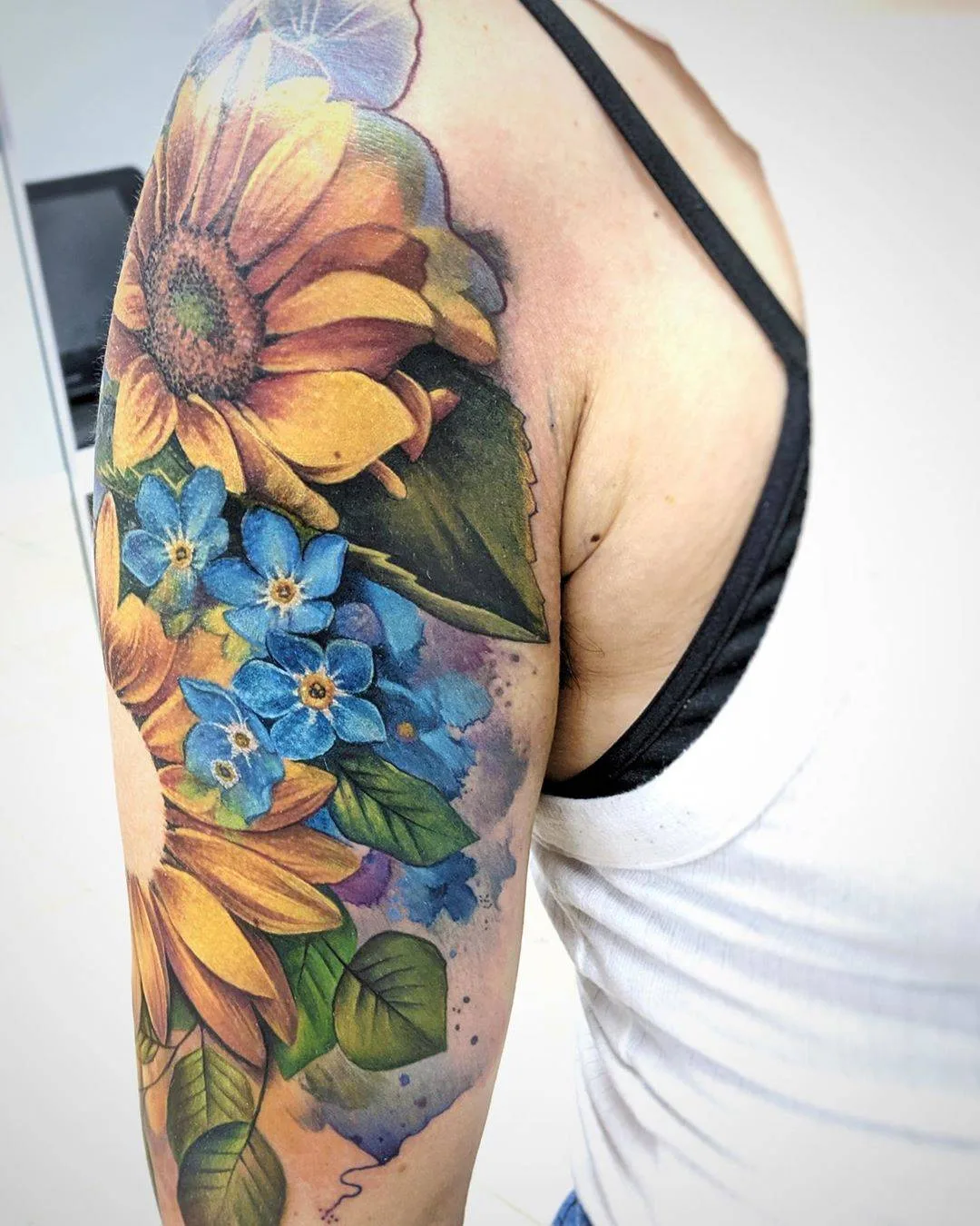Tattoo artist Lianne Moule, color watercolor flowers tattoo | United Kingdom