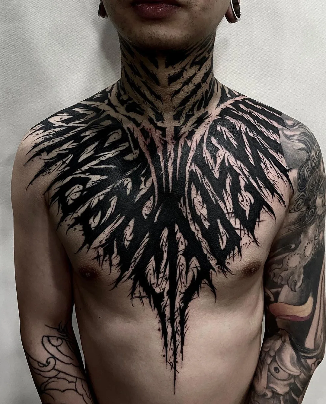 Lettering-style chest tattoo - artist ink_ddd