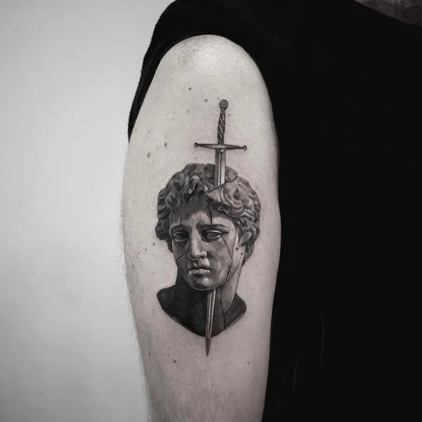 Realism Statue, Sword tattoo on Upper Arm