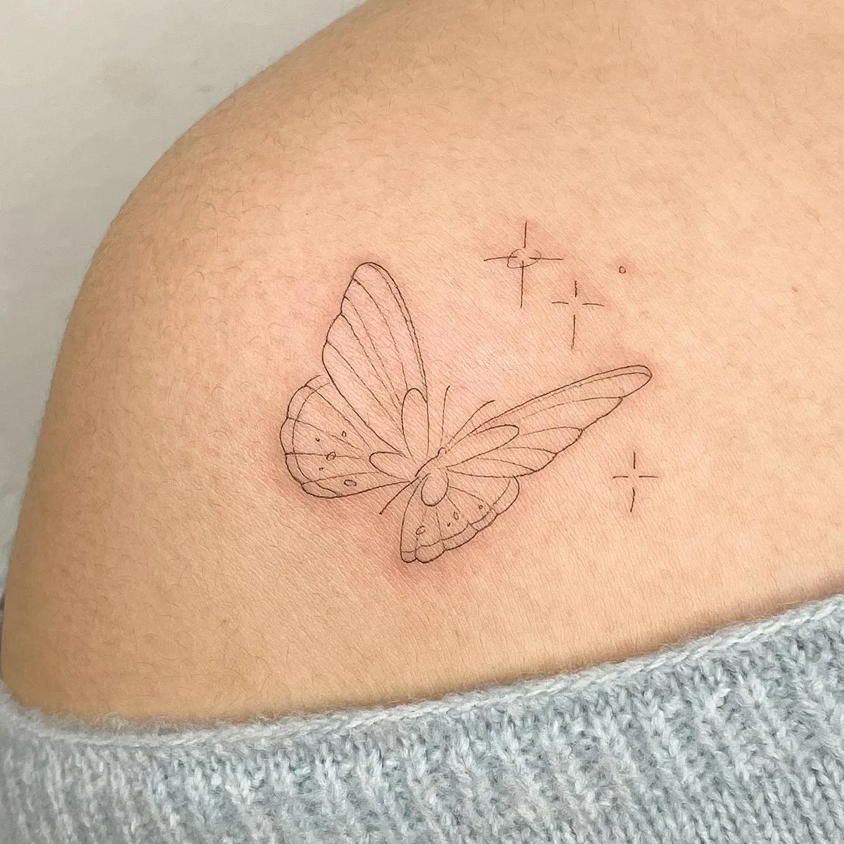 Fine line butterfly tattoo by Sop Tattoo