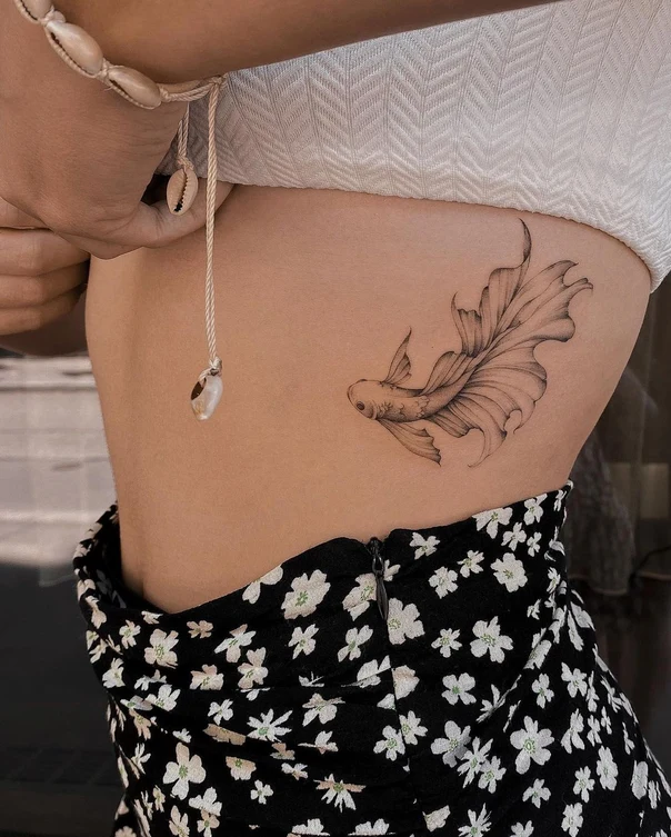 Fineline Fish tattoo on Ribcage