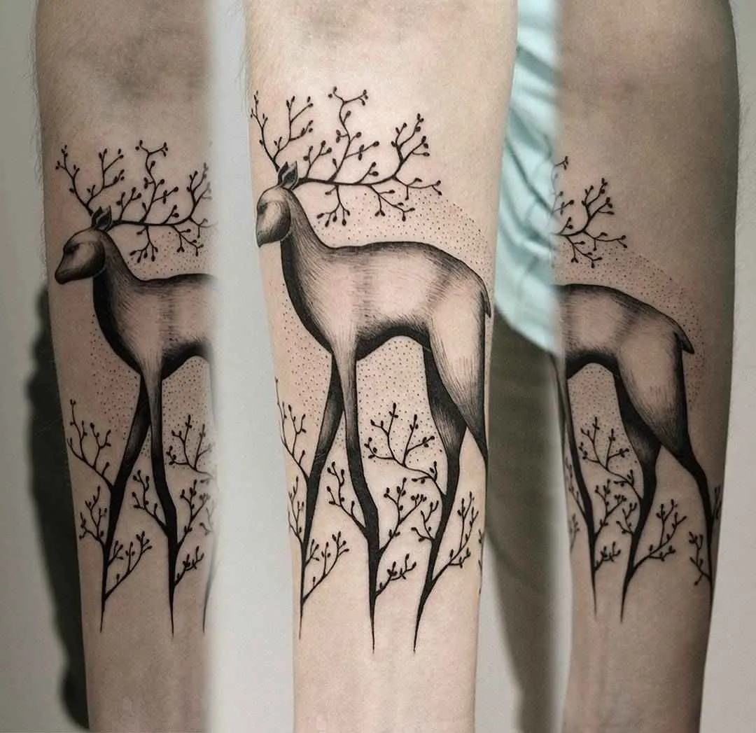 A black and grey tattoo of a deer whose antlers branch like trees, surrounded by stylised trees, using linework and dotwork.