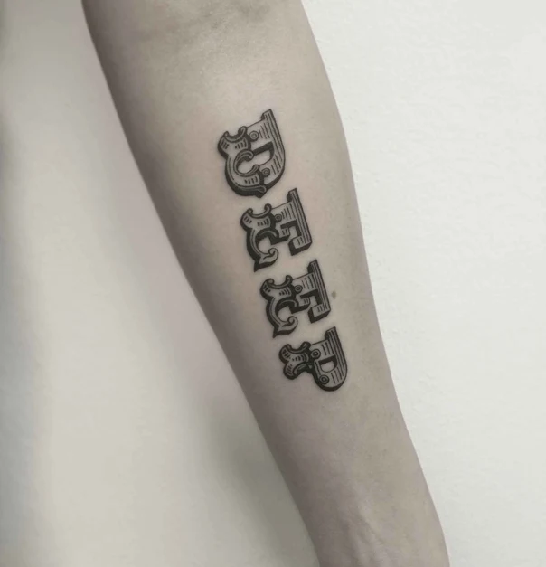 Lettering Letter tattoo on Forearm