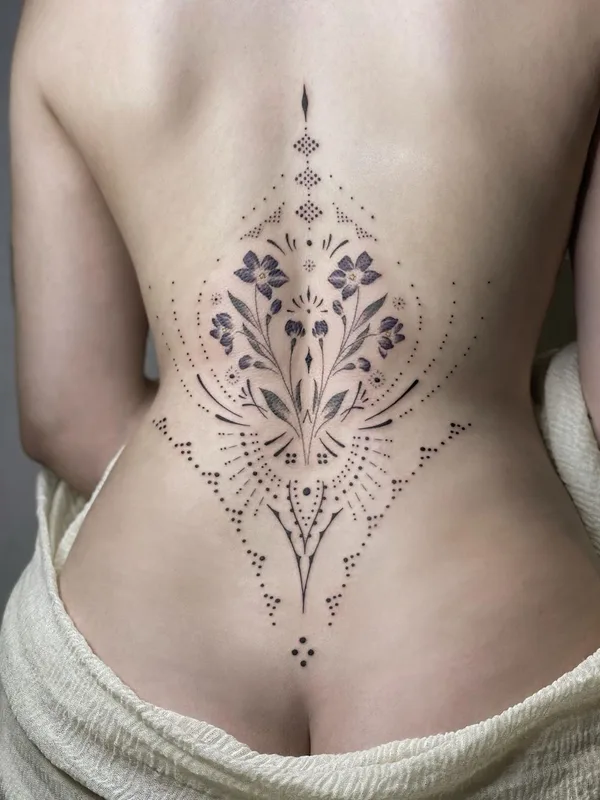 female black and grey ornamental Tatuaggio su lower back #41964 | Tatuatore Blum