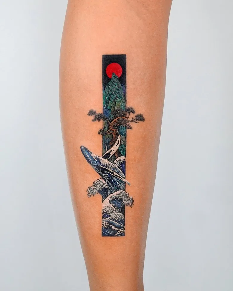 A rectangular tattoo featuring a whale breaching through waves with a mountain and tree in the background.