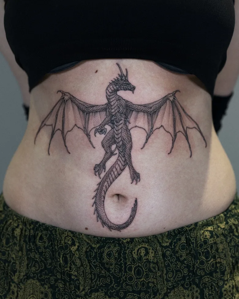 Tatuaggio a linee sottili di draghino realizzato da Intat