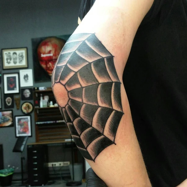 Blackwork Spiderweb tattoo on Elbow
