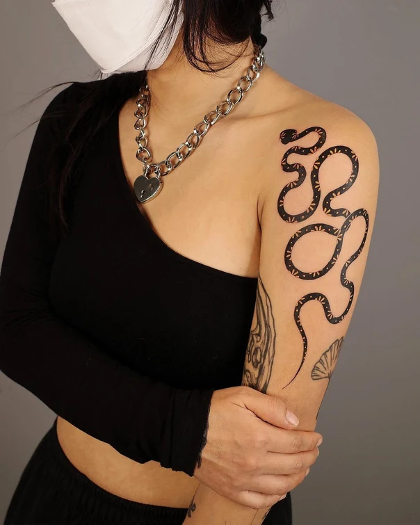 Linework Snake tattoo on Upper Arm