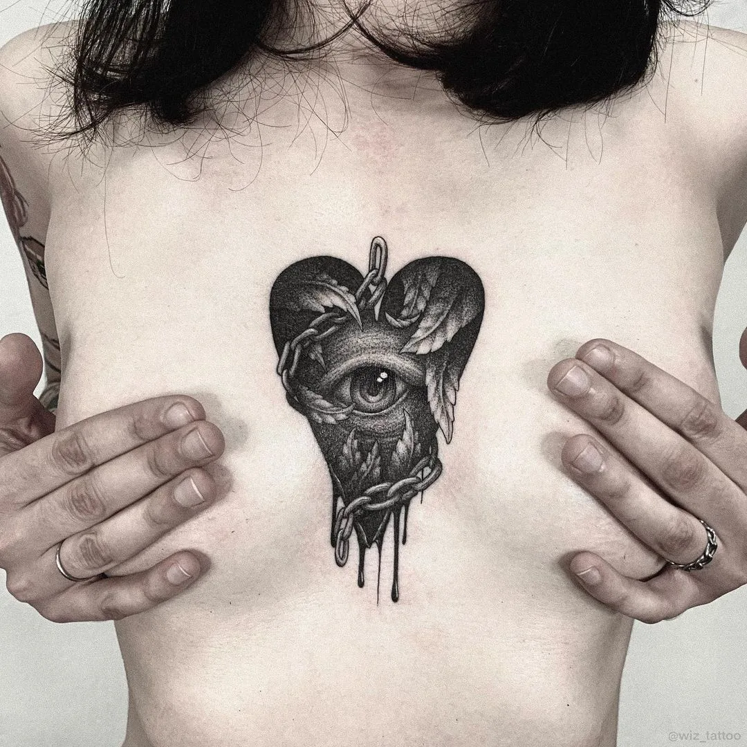 Slavic horror tattoo on breast by Evgeny Wiz
