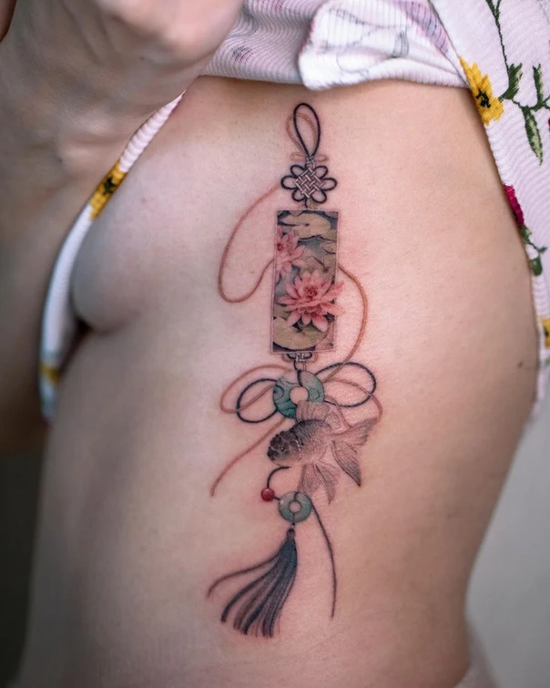 Illustrative Fish, Flower tattoo on Ribcage