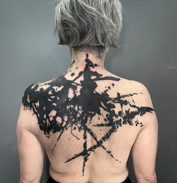 Blackout tattoo on Upper Back