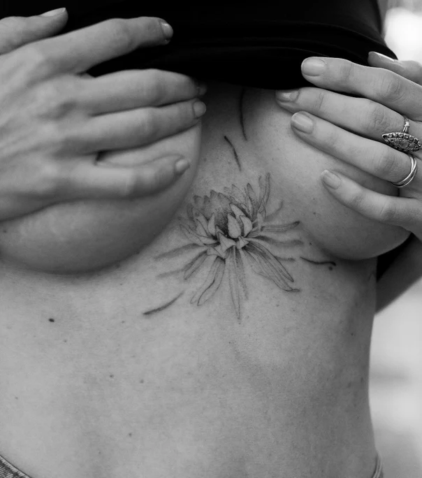Fineline Flower tattoo on Sternum