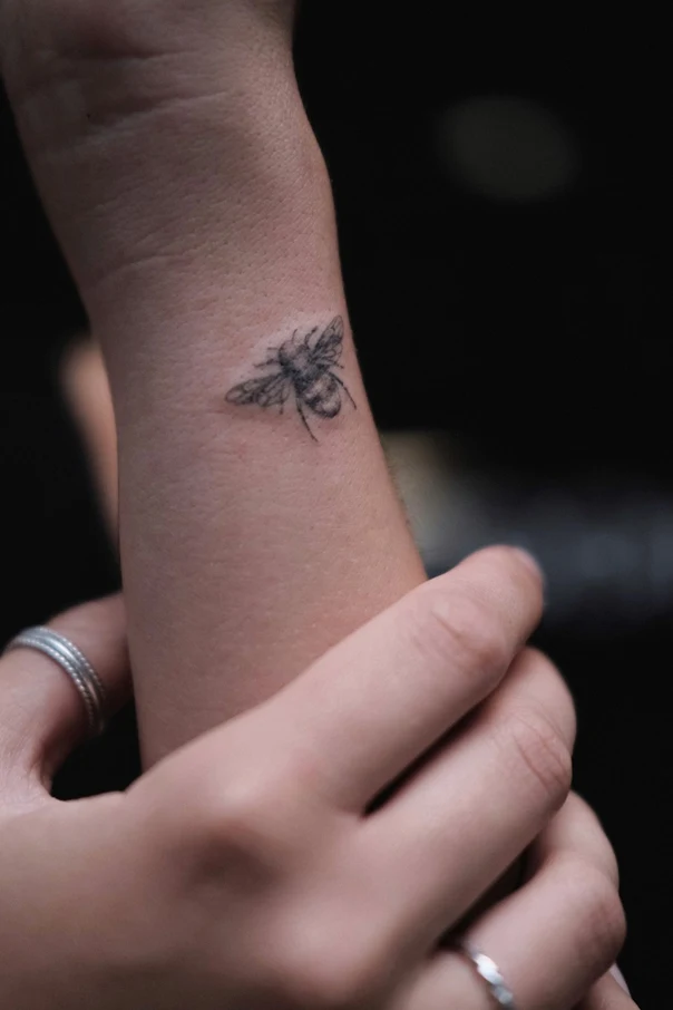 Linework Bee tattoo on Wrist