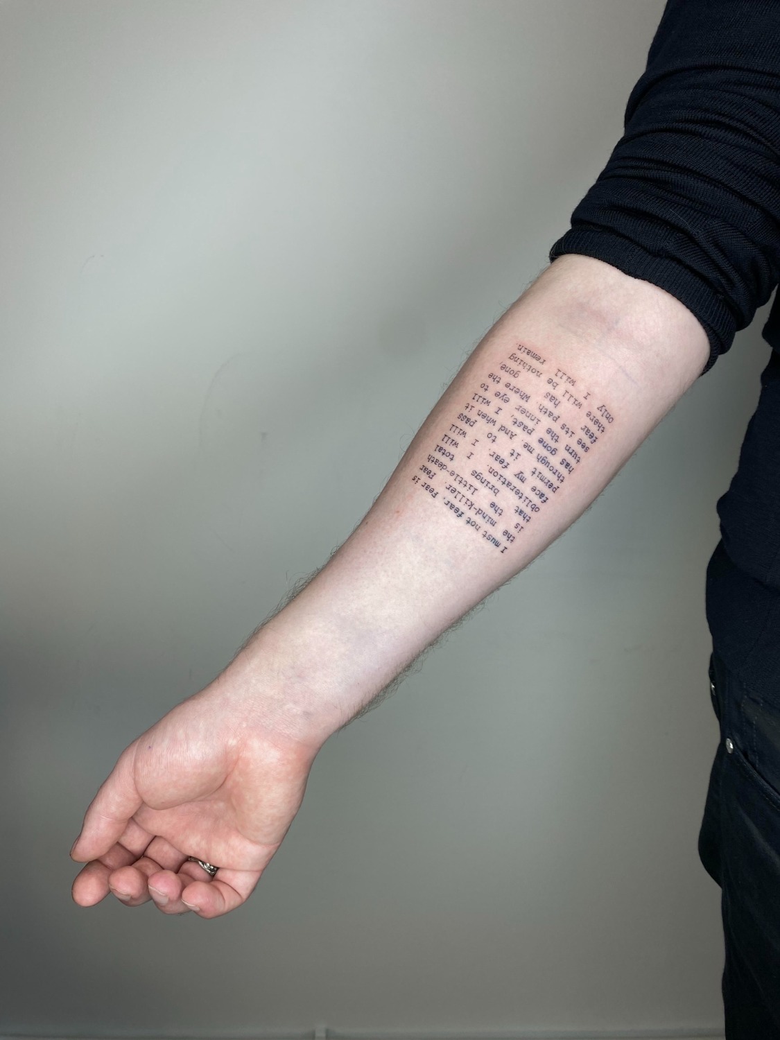 A reporter sports a tattoo with a quote reading in part fear is the  mindkiller as she interviews US Senator Rand Paul RKY on his way to  the Senate floor for a