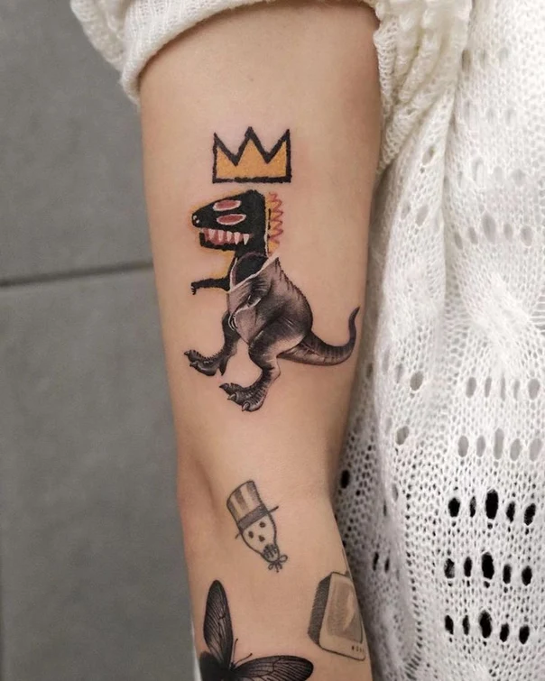 Illustrative Dinosaur, Crown tattoo on Upper Arm
