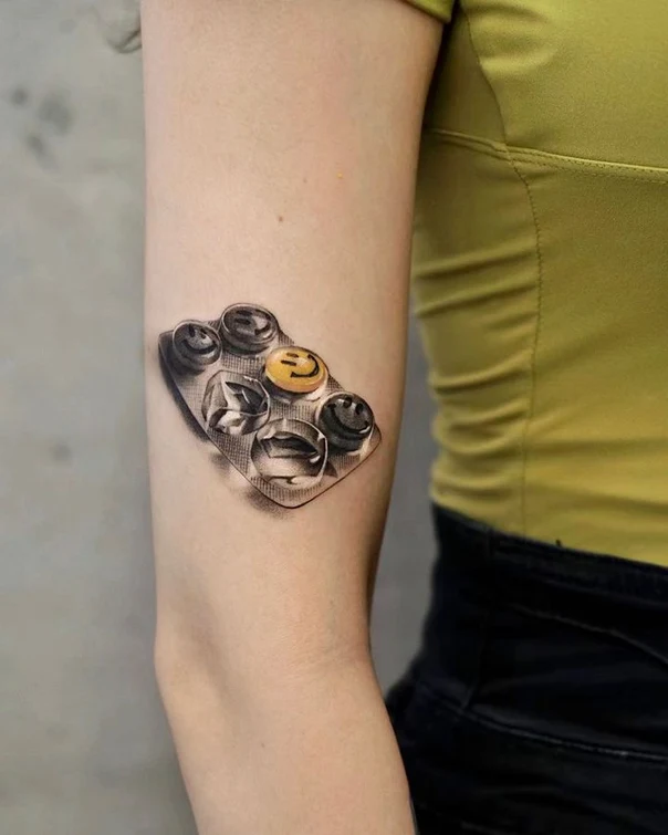 Realism Pill packet, Smiley face tattoo on Upper Arm