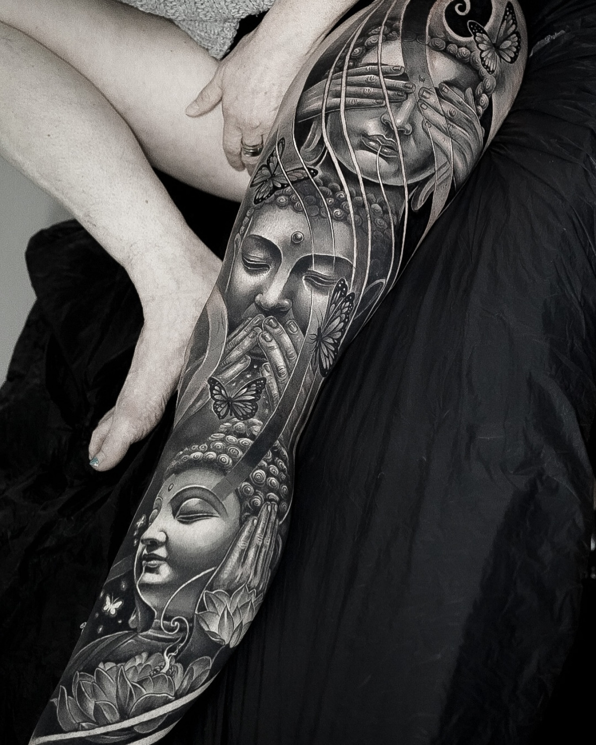 Black and grey realistic Buddha leg sleeve tattoo by Edi Contreras