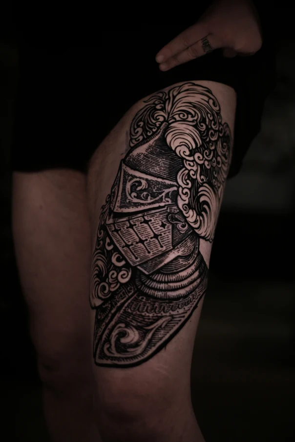 Engraving Helmet tattoo on Thigh