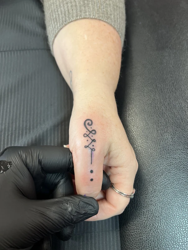 Linework Symbol tattoo on Finger