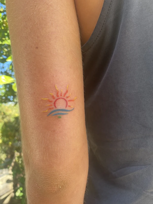 Illustrative Sun, Ocean tattoo on Forearm