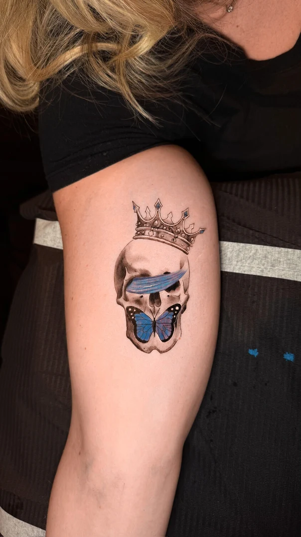 Illustrative Skull, Butterfly tattoo on Upper Arm