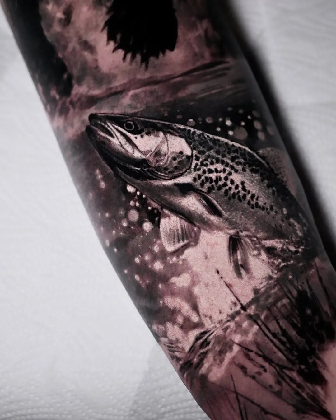 Realistic black and gray fish tattoo