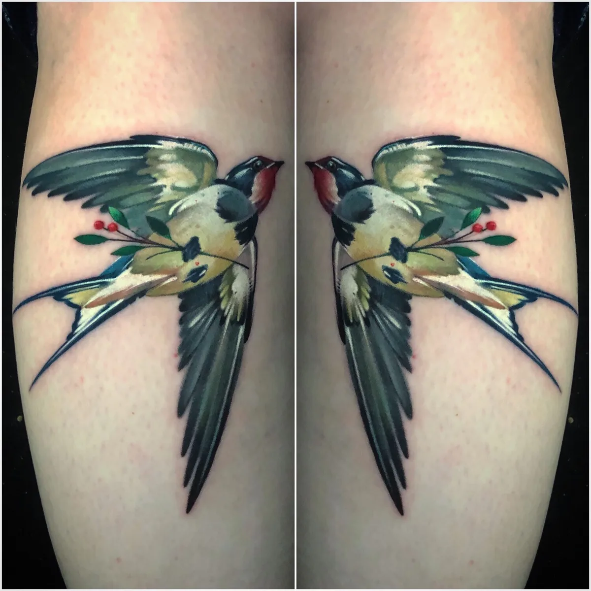 Tatuaggio di due rondini con ali in stile acquerello e un ramoscello di bacche, realizzato con colori vivaci e sfumature morbide.