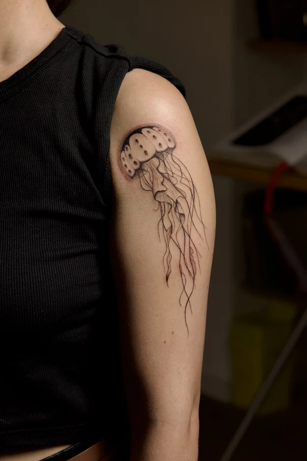 Linework Jellyfish tattoo on Upper Arm