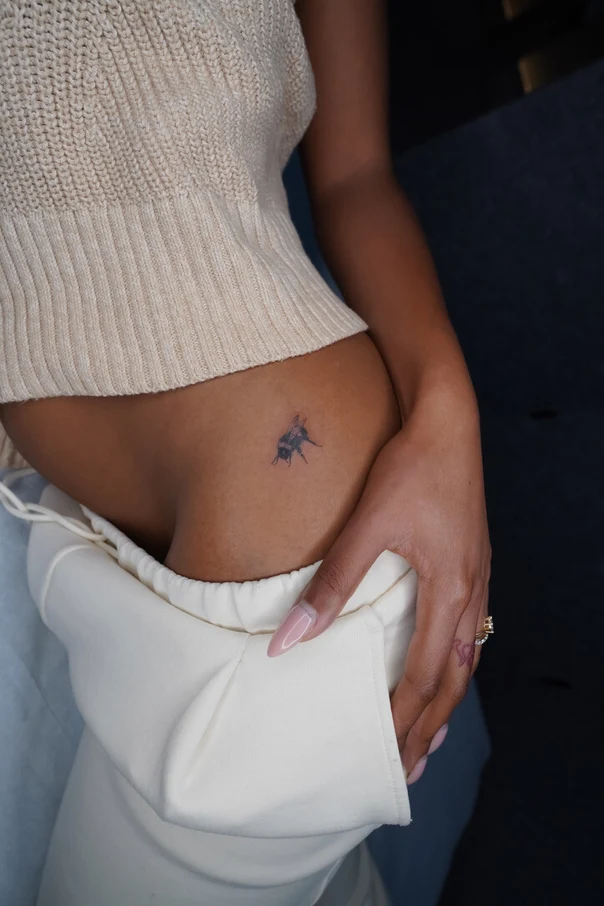 Fineline Bee tattoo on Hip