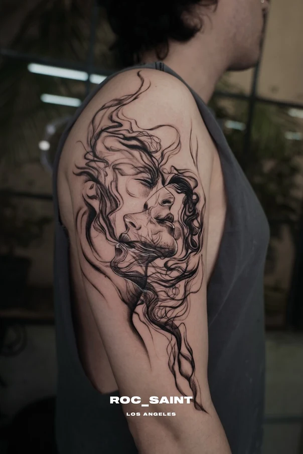 Sketch Face tattoo on Upper Arm