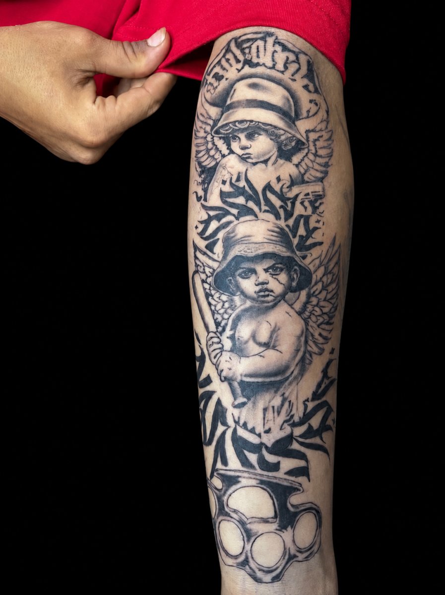 Chicano Cherub, Brass knuckles tattoo on Calf