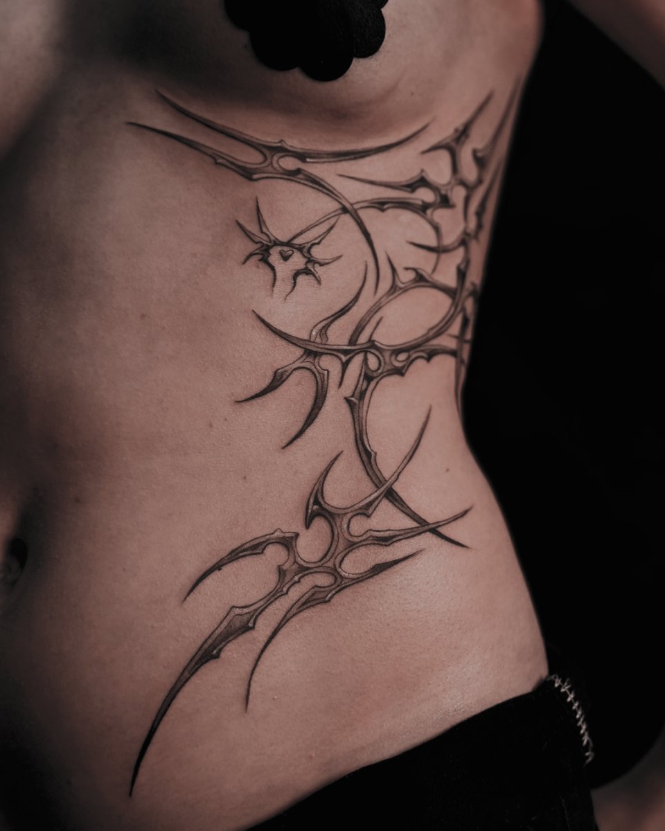 Linework Spikes, Tribal flourish tattoo on Ribcage