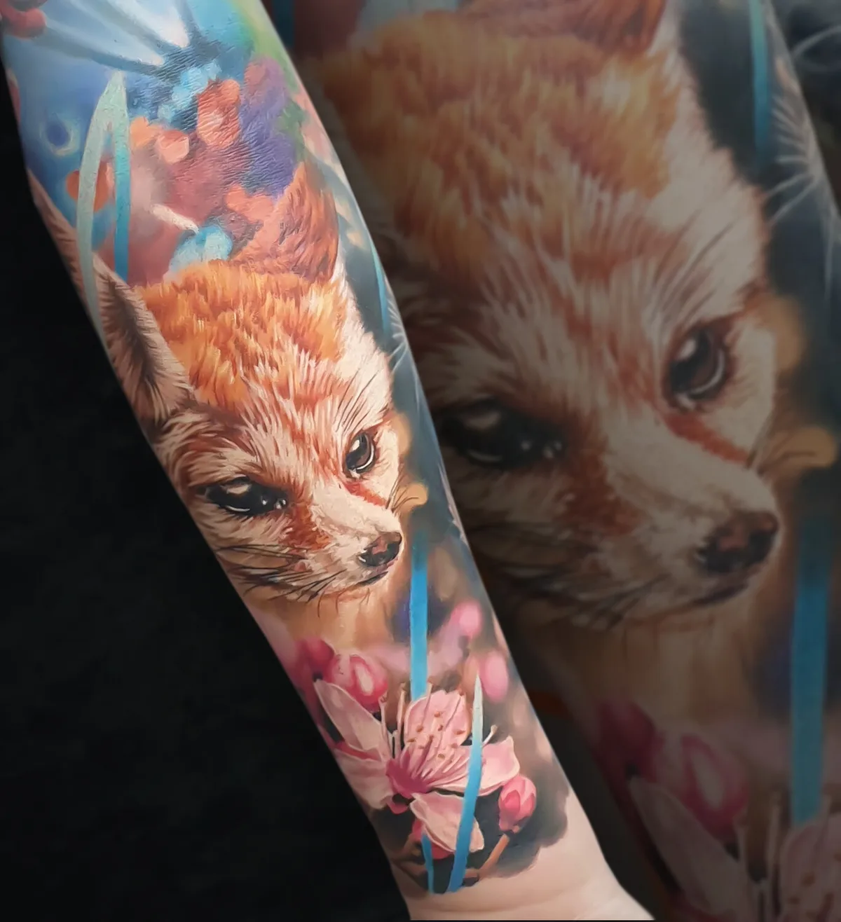 A vibrant full-sleeve tattoo featuring a realistic fox among cherry blossoms in a Japanese traditional style.
