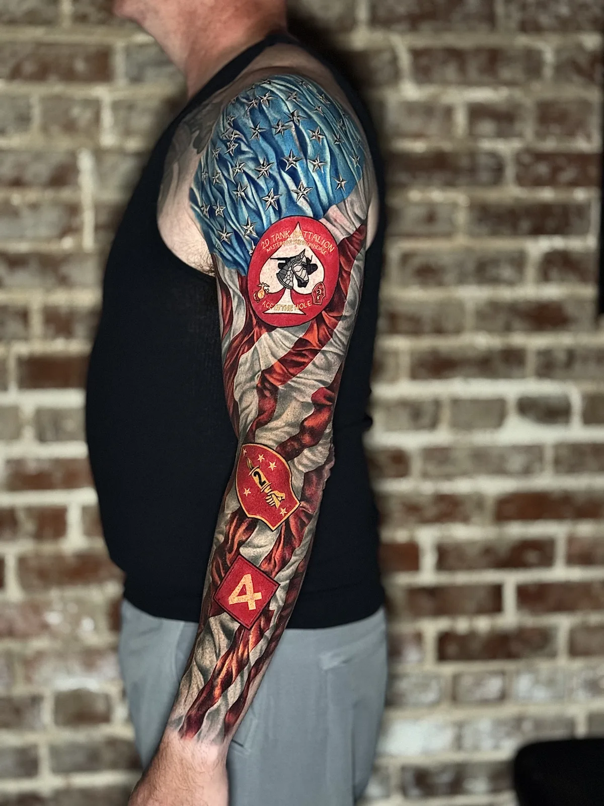 Full color tattoo sleeve with a playing card, dice and flag motifs