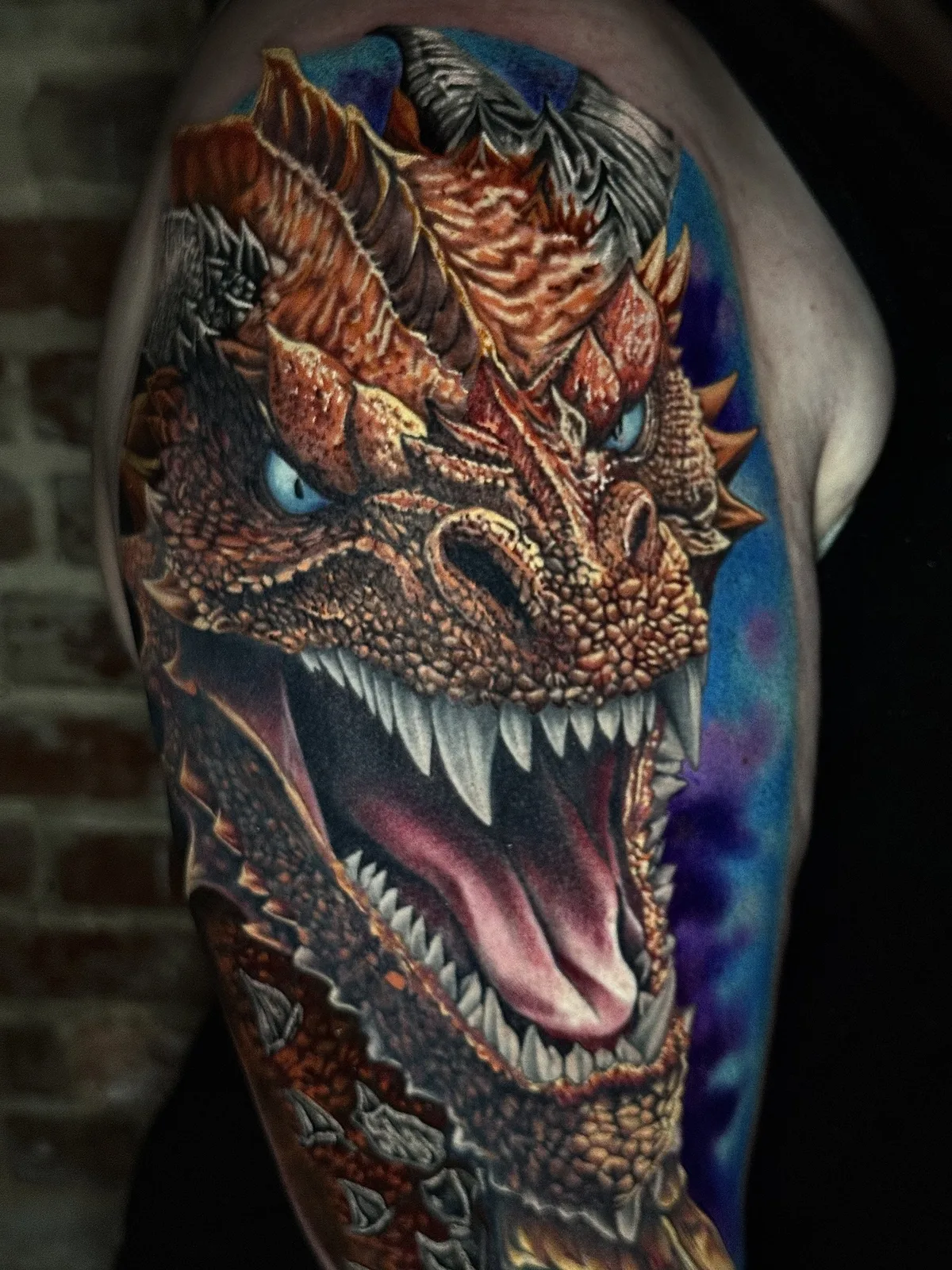 Full color realism dragon tattoo running from the shoulder to the elbow