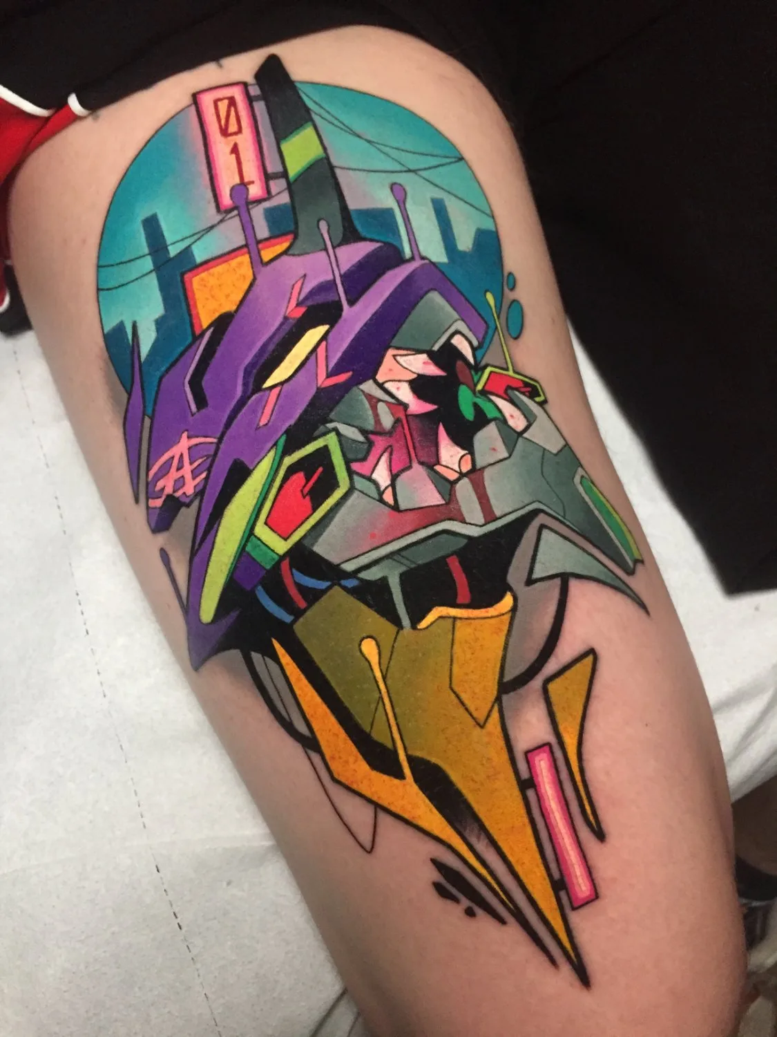 A thigh tattoo showing the angular purple head of an Evangelion mecha against a circular blue background, with green eye accents, pink and green mechanical mouth details, and abstract yellow geometric shapes below, with a pink sign reading '01' in the upper left.