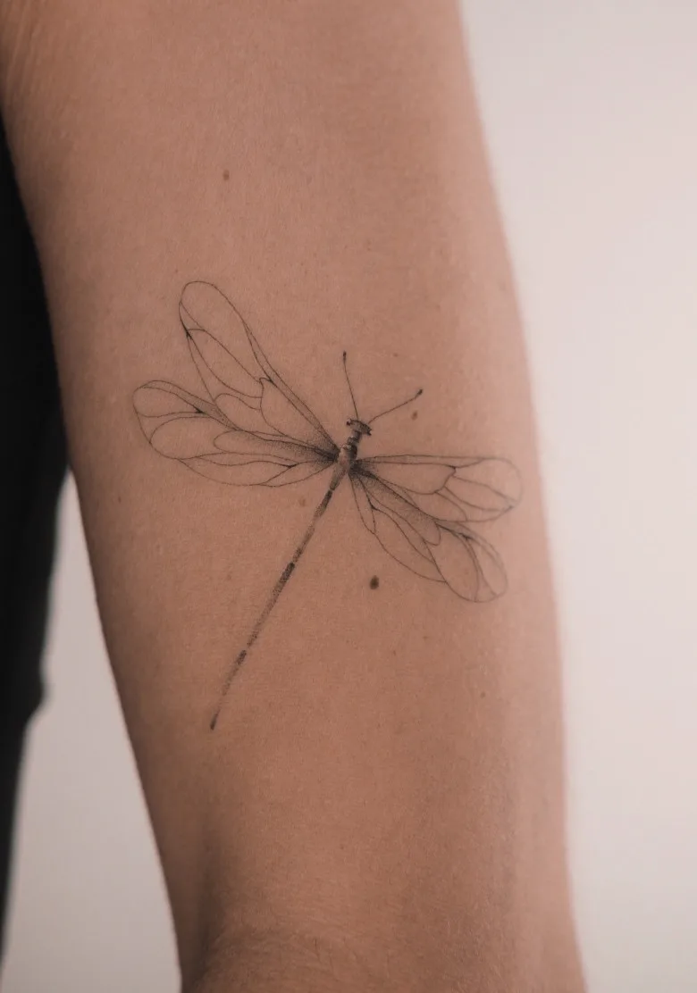 Fine line dragonfly tattoo by Ksenia Way Ink