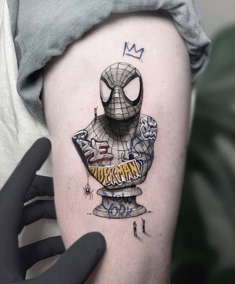 Embroidery style Spider Man tattoo located on the upper