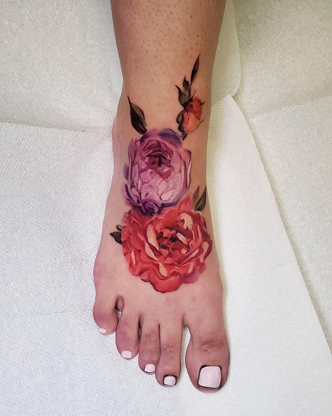 Tattoo artist Pete Zebley, color watercolor flower tattoo for girls | United States
